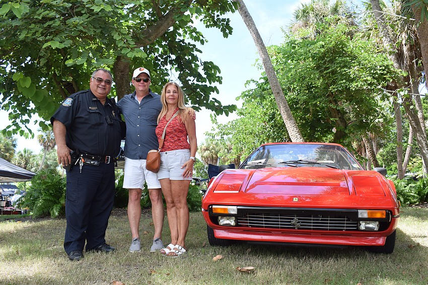 Officer Cliff Cespedes, Christian and Patrice Martin at Exotic Cars on the Circle.