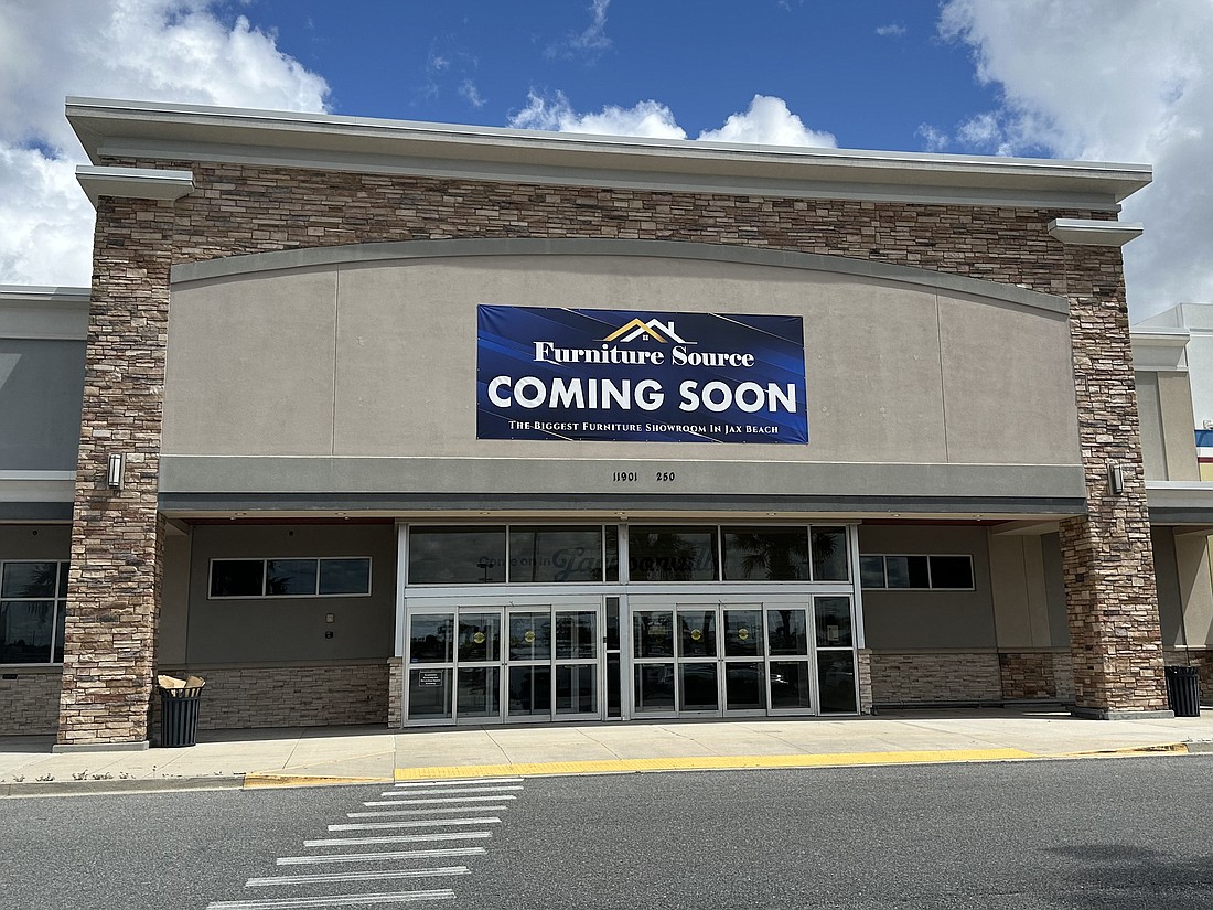 A Furniture Source banner is up at the closed Earth Fare store in the Atlantic North shopping center in East Arlington.