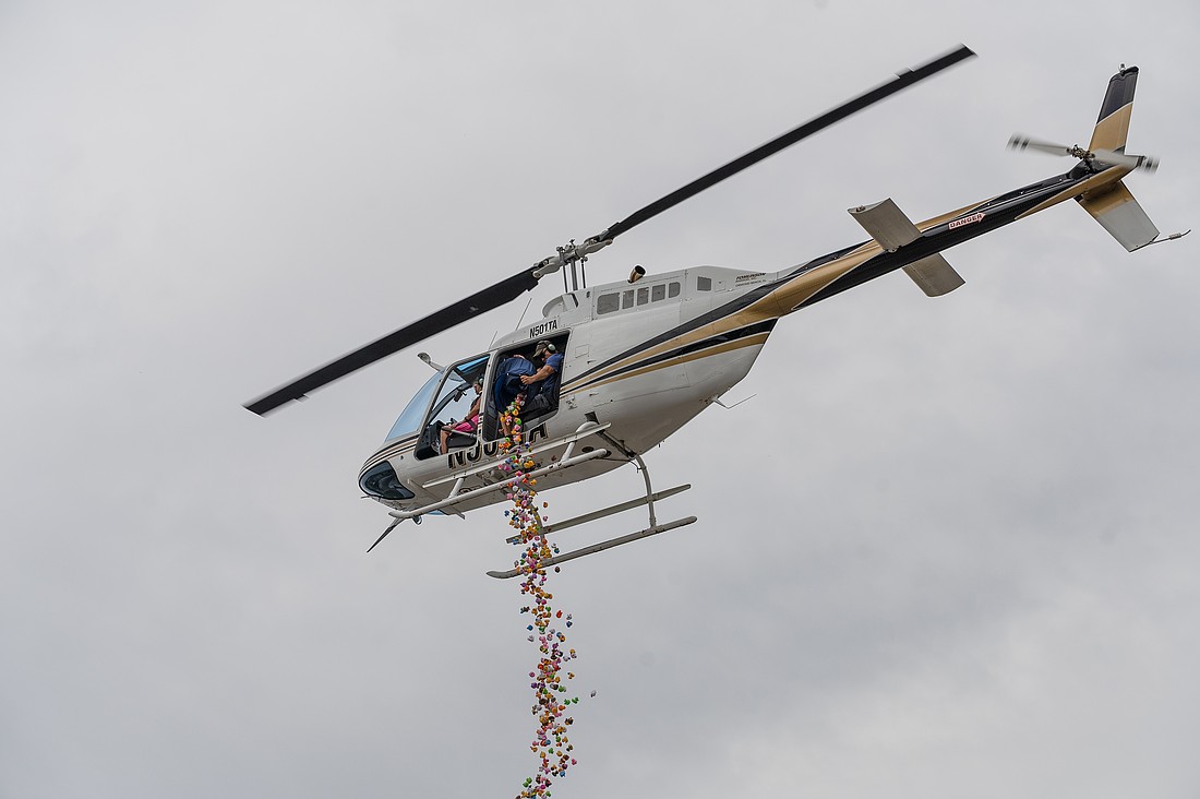 Tomlinson Aviation employee Joe Horton drops the rubber ducks onto the Ormond Beach Elks Lodge parking lot during the second annual Elks Duck Drop. Photo by Michele Meyers