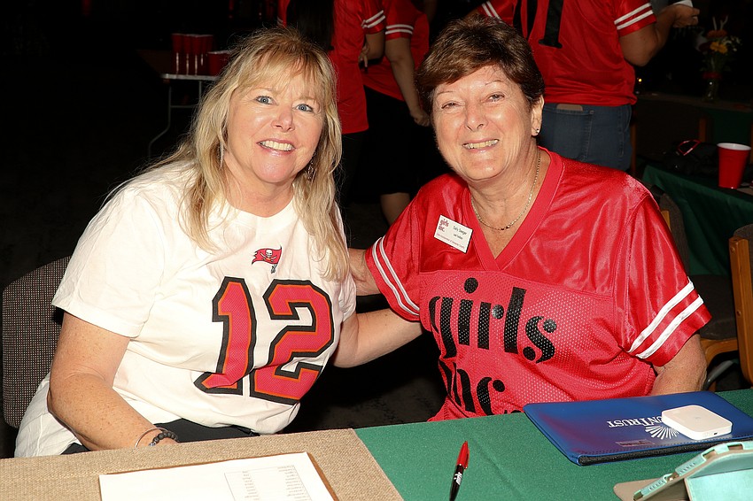Girls Inc. Counselor Cindy Gourley, and Lead Facilitator Sally Seeger check guests in at the Totally Tailgate event.
