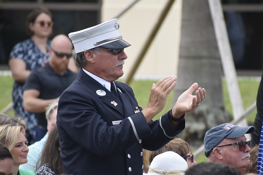 9/11 first responder and former lieutenant Benjamin Maggio, of Bradenton, applauds during the ceremony.