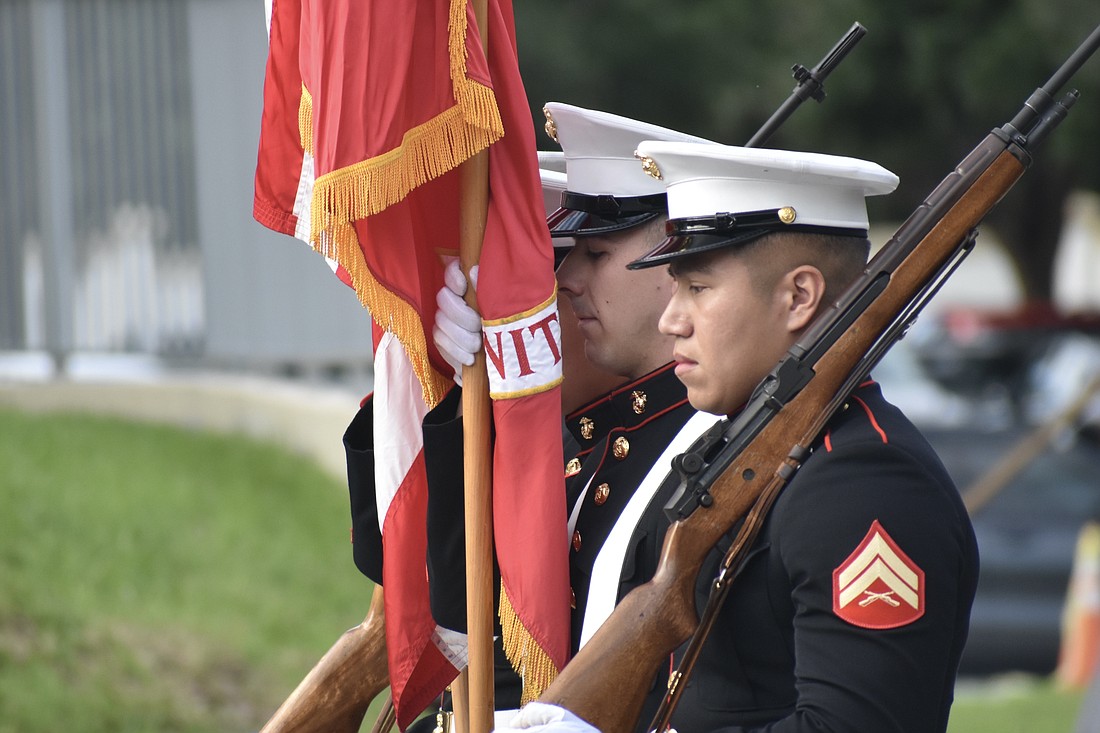 The color guard, including Cpl. Christopher Short and Cpl. Antonio Martinez (pictured) march in the ceremony.