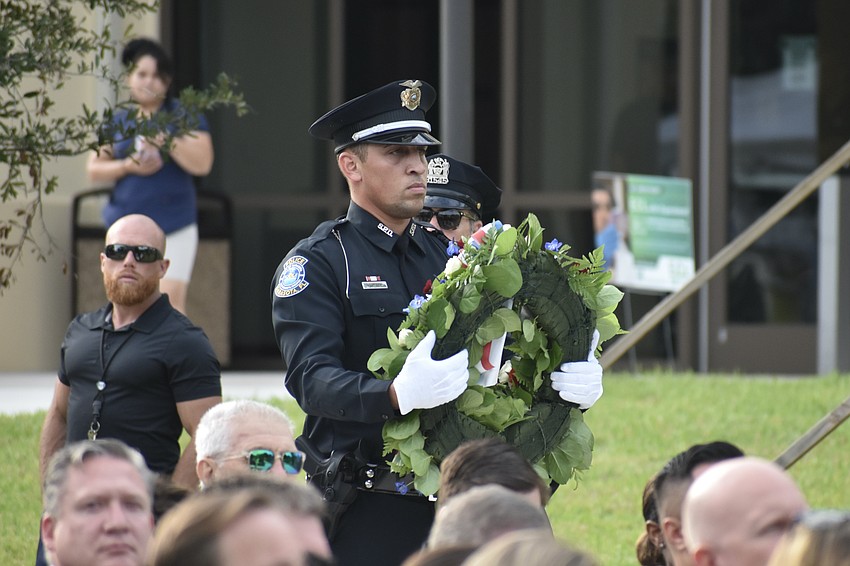 Sarasota Police Department Officer Oscar Martinez II proceeds to lay a wreath during the remembrance.