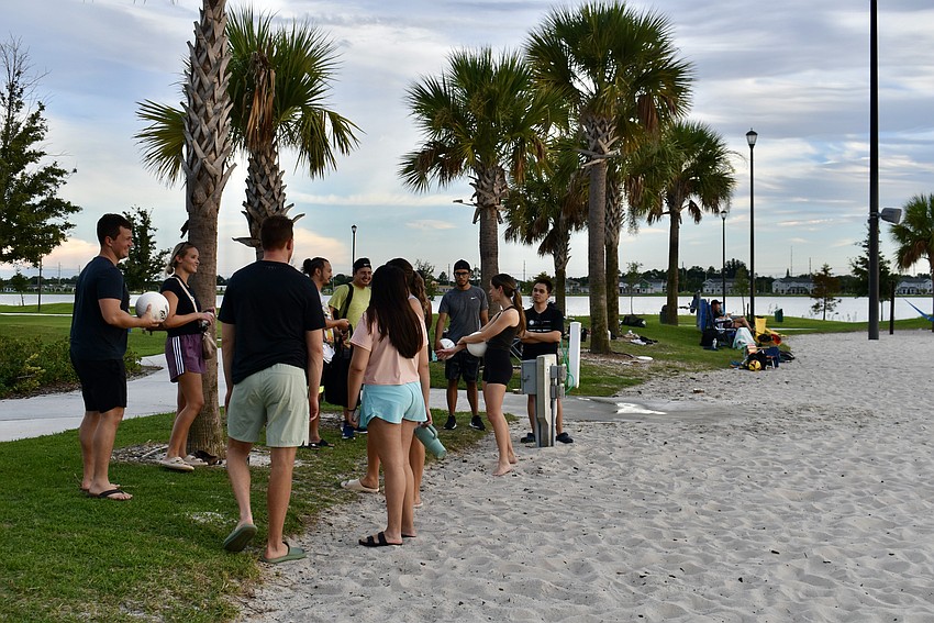 A group of late arrivals wait for some courts to clear.