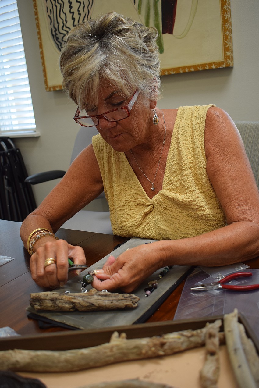Sallie West making a suncatcher at the Paradise Center.