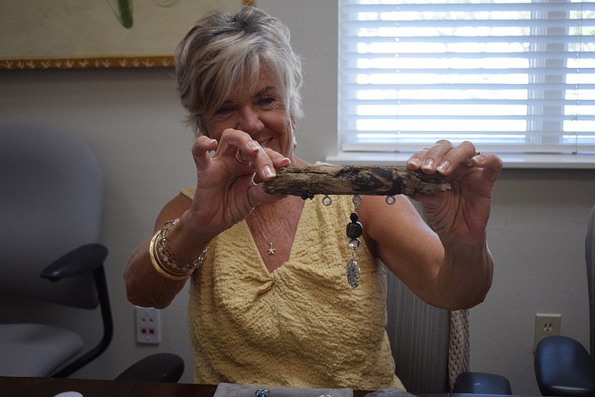 Sallie West making a suncatcher at the Paradise Center.