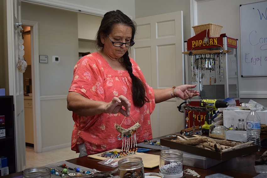 Debbie Lemieux uses driftwood as the suncatcher's base and then adds crystals, beads, medallions, keys and more.