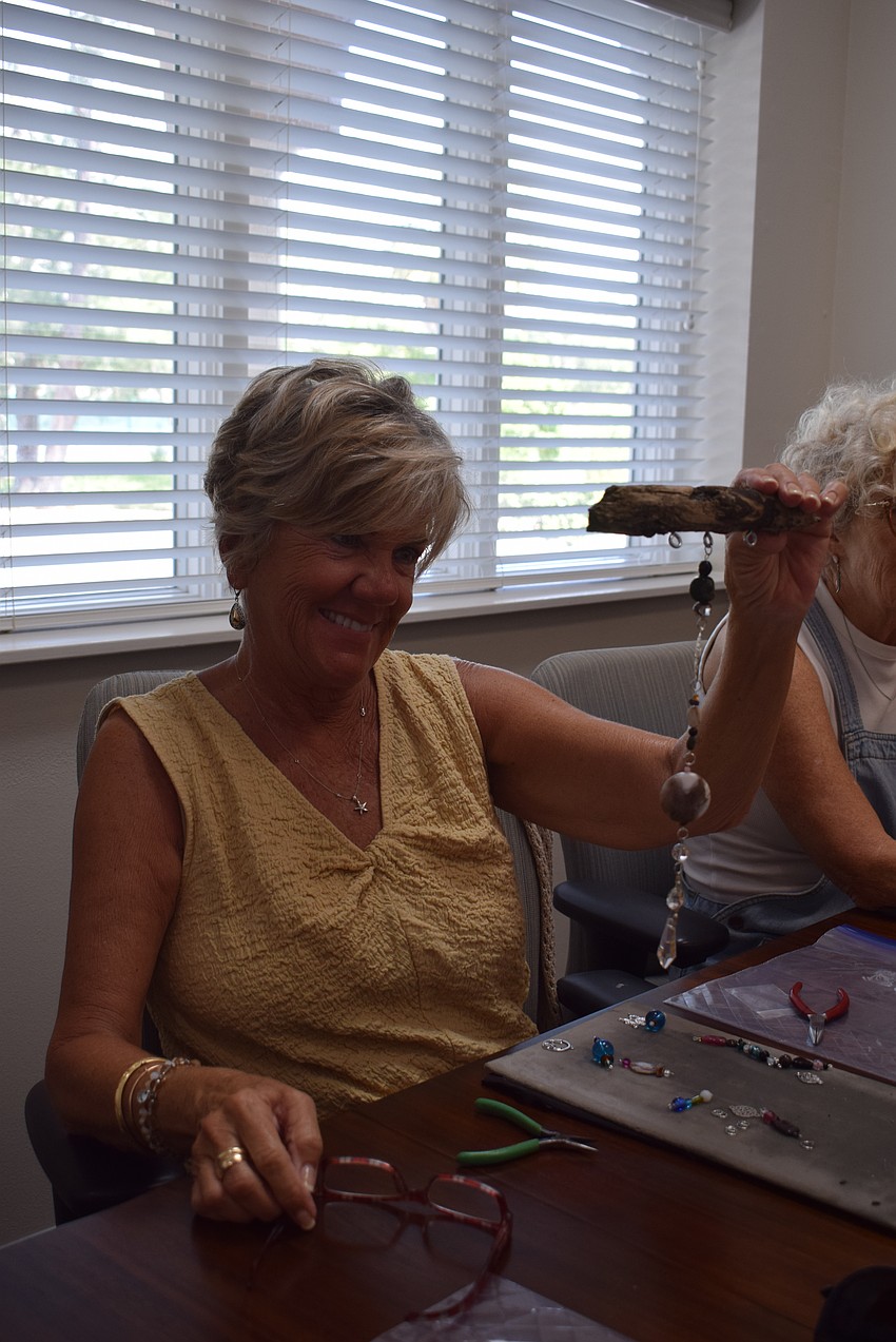 Sallie West making a suncatcher at the Paradise Center.