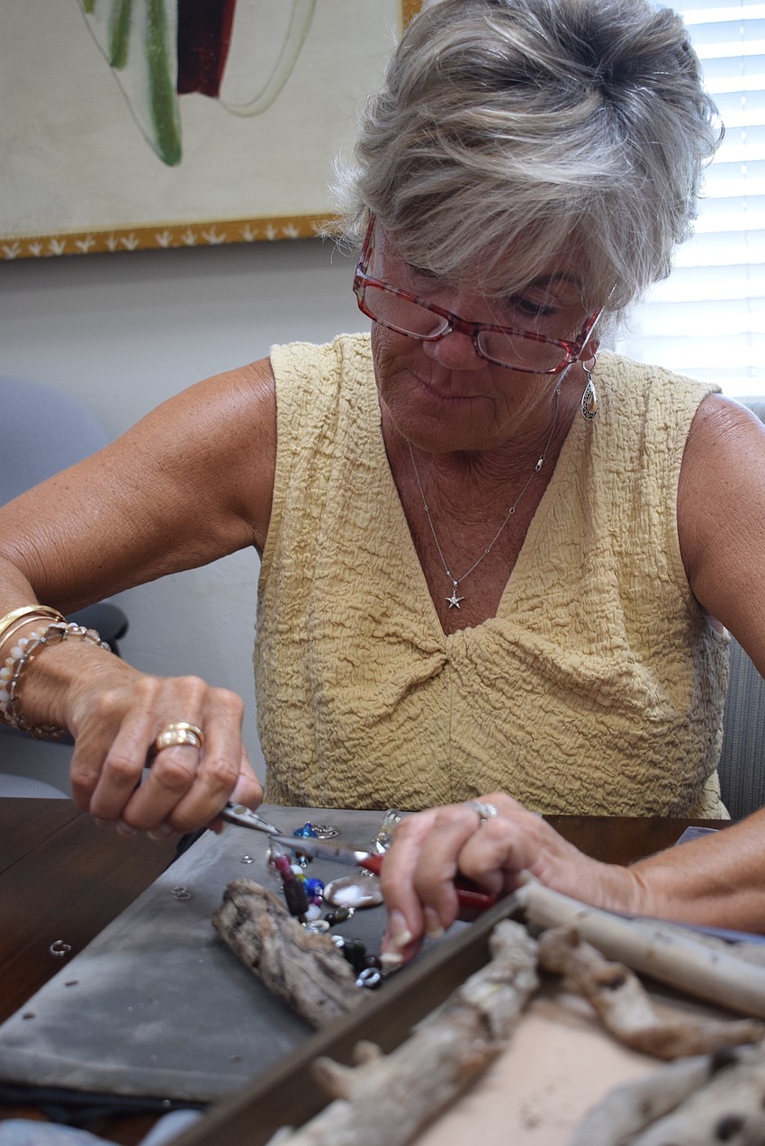 Sallie West making a suncatcher at the Paradise Center.