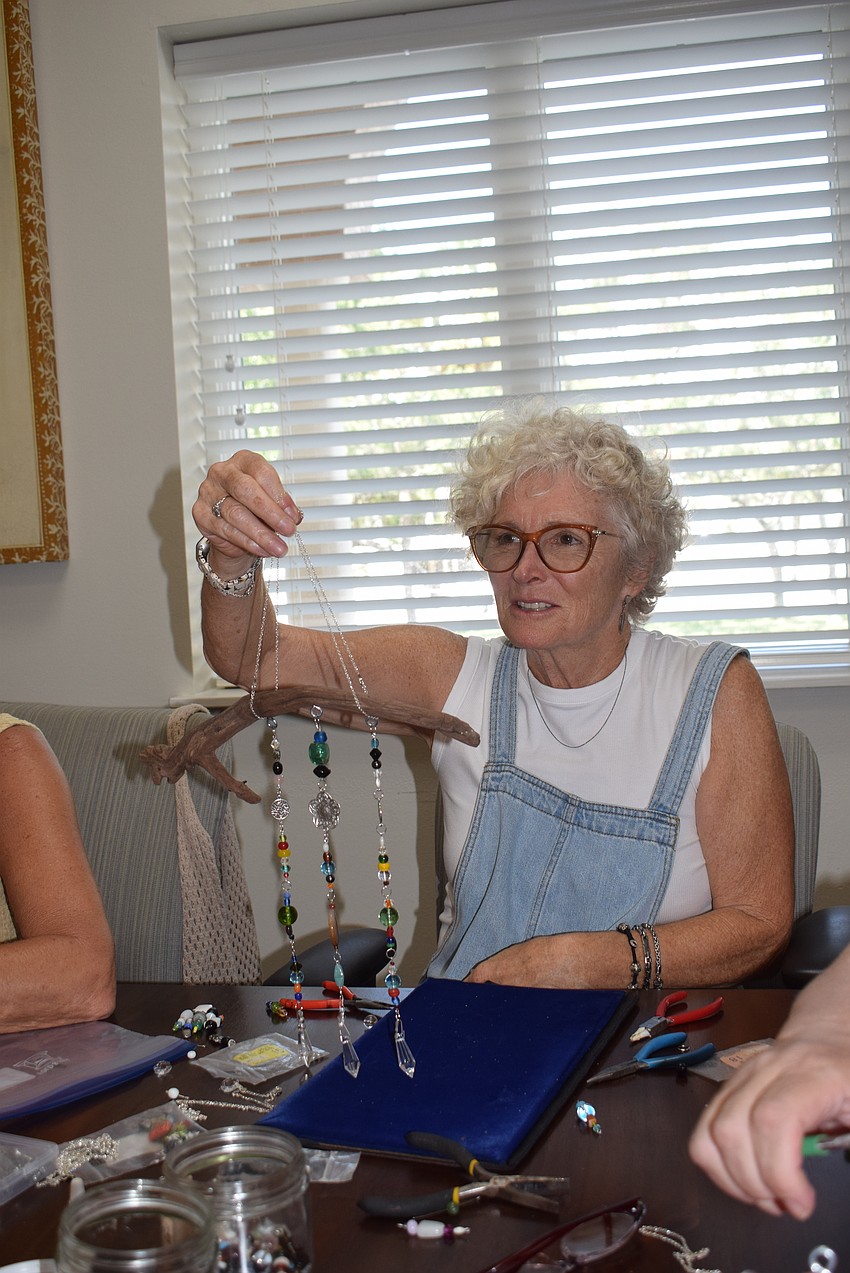 Donna Powell with her finished suncatcher at the Paradise Center.