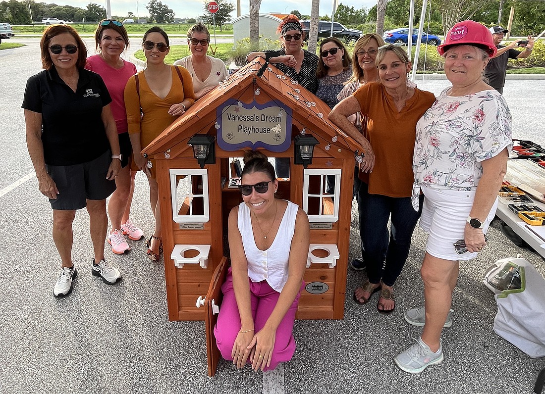 Members of the Suncoast Builders Association's Professional Women in Building Council complete a playhouse for a 5-year-old girl who has cancer.