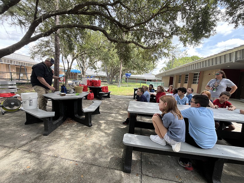 Damon Moore, the executive director of Oyster River Ecology Inc., talks to a class of third graders about oysters during Everglades Week.