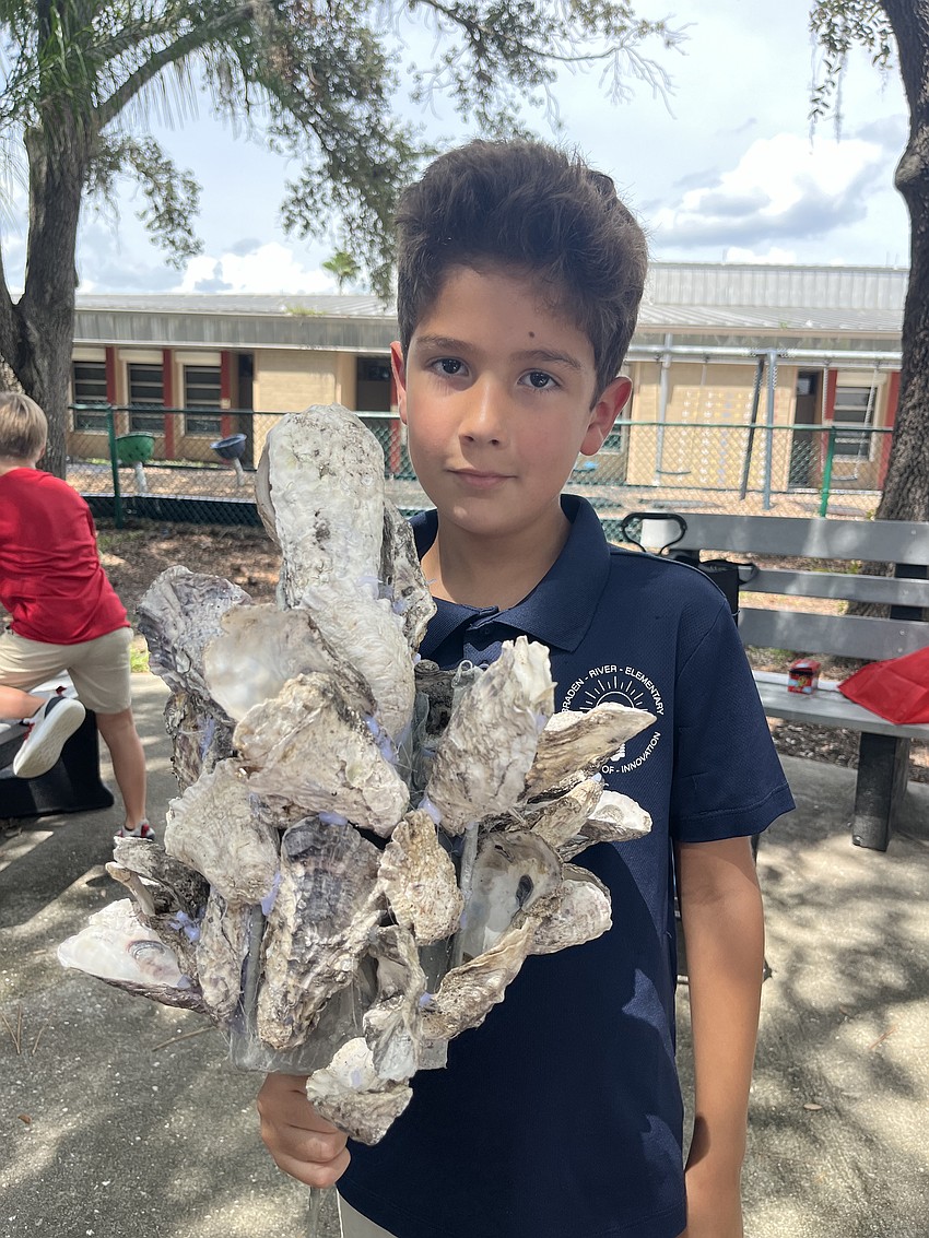 Third grader Ethan Boardman admires the oyster rag pot. It took about a year and a half for the pot to look this way.