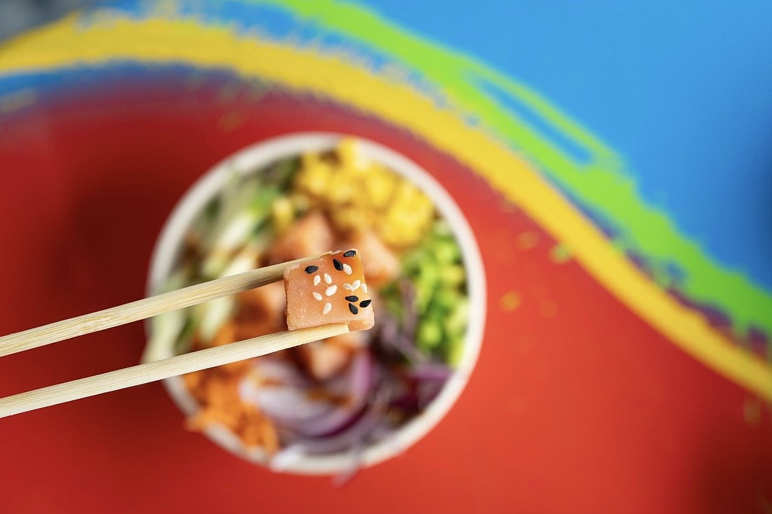 Customers can enjoy the poke bowls atop tables made from the colorful skimboards at Zap Skimboards in Venice.