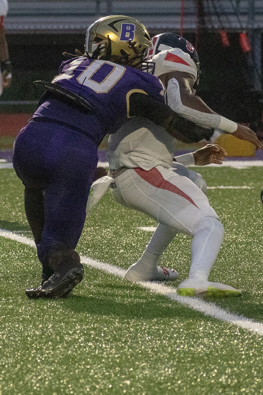 Booker junior defensive lineman Kevontay Hugan (10) takes down Carrollwood Day quarterback Jordan Magwood.