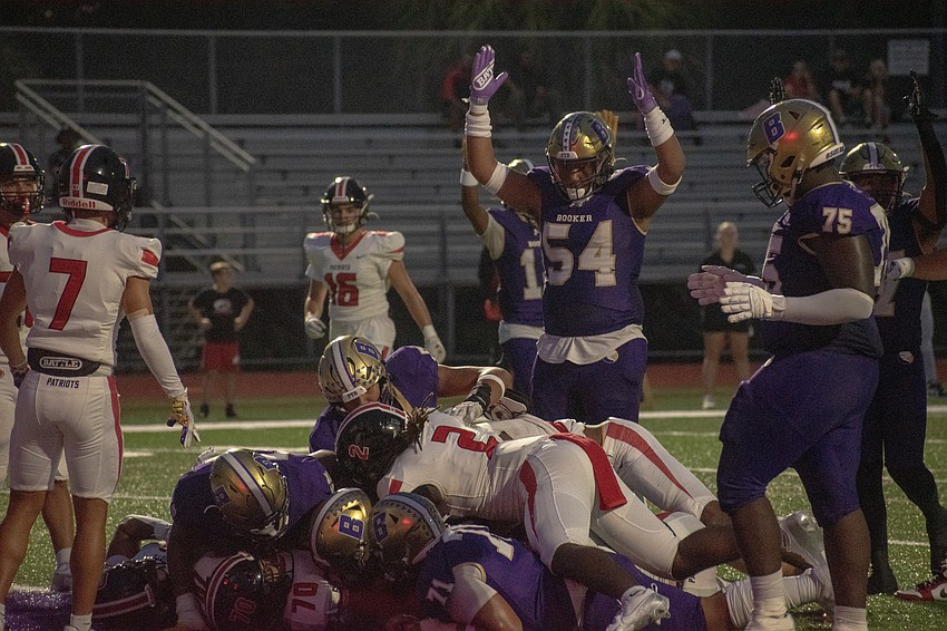 Booker junior Jaleel Williams (54) signals for a touchdown on a run by senior running back Rashawn Peterson. The Tornadoes did score on the play.