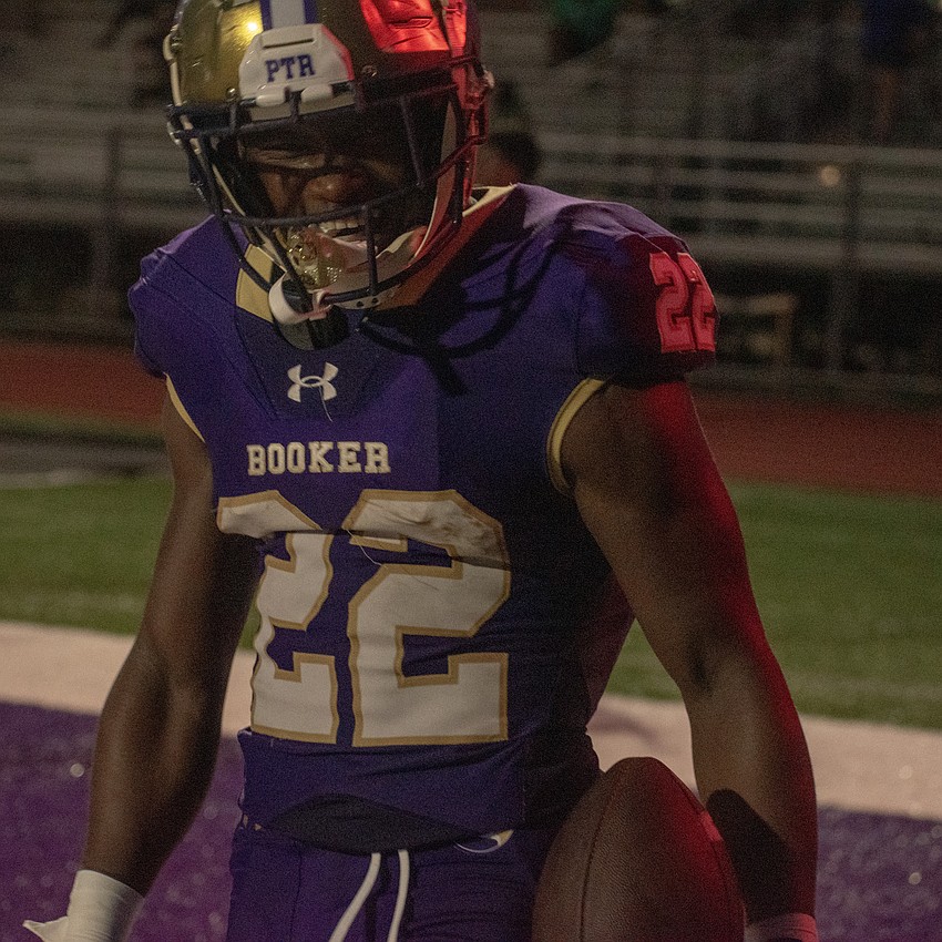 Booker senior running back Deanwar Johnson smiles after scoring a touchdown against Carrollwood Day School.