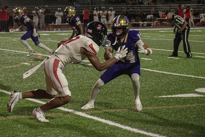 Booker cornerback Rex Schwartz locks up Carrollwood Day wide receiver Christian Clarke. Schwartz would intercept a pass on the play.