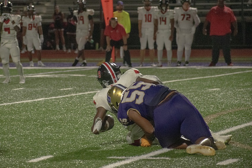 Booker senior defensive lineman Jordan Radkey (55) takes down a Carrollwood Day running back.