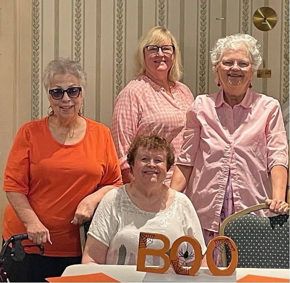 Theresa Adazzio, Dr. Pam Fieldus, Vivian Moreau, and President Diane Lessard (seated) review decorations for the Palmetto Club’s Halloween Party on Oct. 19, at the Palmetto Club. Courtesy photo