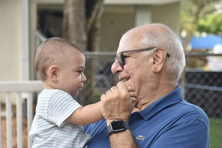Zachary Azerad, 1, enjoys time on the playground with his grandfather Isaac Azerad.