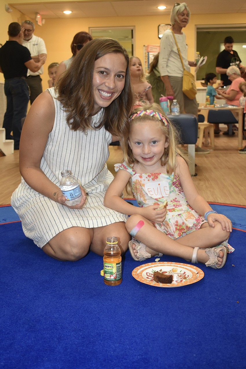 Natalie Yader and her daughter Evie Yader, 4, enjoyed a snack on the rug of the playroom.