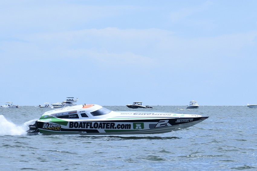 Boatfloater.com of Sarasota, piloted by father and son team Steve Kildahl and Stephen Kildahl of the Sarasota team Scott Free Racing, makes a turn on the course.