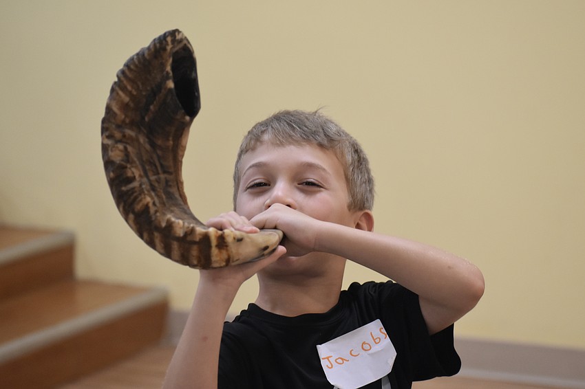 Jacob Shefrin, 6, the son of Rabbi Michael Shefrin, blows the shofar.