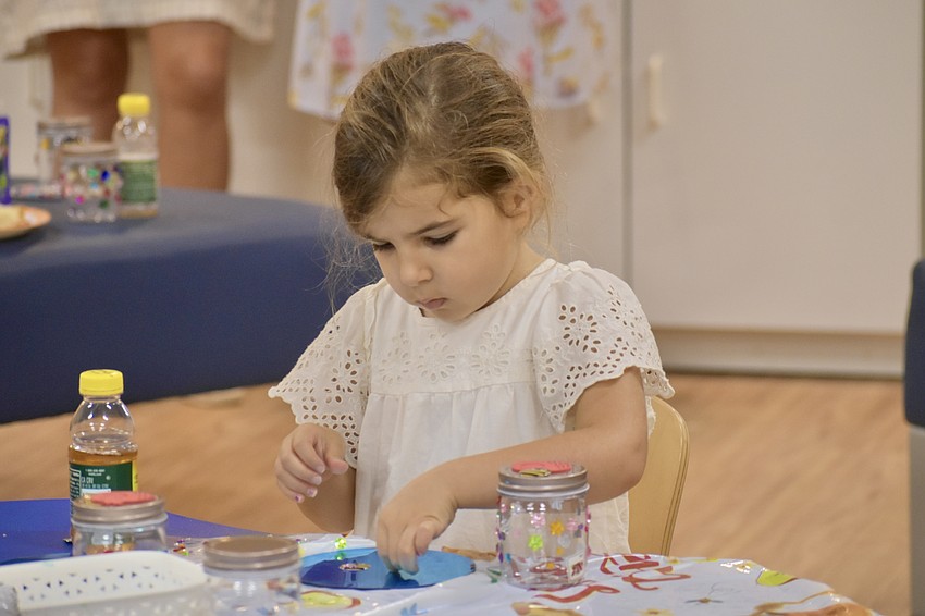 Audrey Cino, 4, performs a craft.