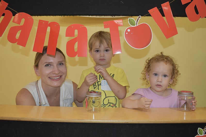 Yana Kevlin and her children Lenny Kevlin, 3, and Ava Kevlin, 2, decided to step inside the photo booth under the 