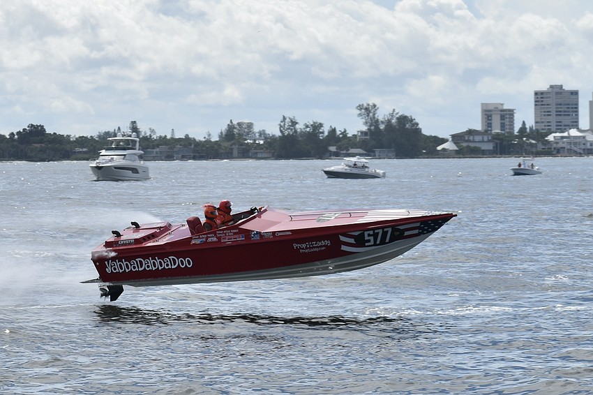 YabbaDabbaDoo of Reddick, Florida, with JD Ivines and Steve Adams, makes a leap from the water.
