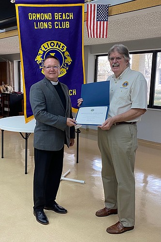 Pastor Roy Allison and Ormond Beach Lions Club President Dennis Sweeney.