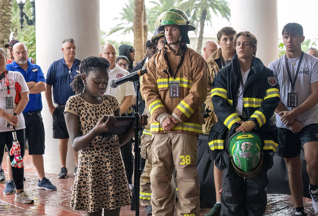 Amber Robinson, a middle school student from Flagler Schools, reads a speech at the opening ceremony for the 9/11 Memorial Stair Climb. Photo courtesy of the 9/11 Memorial Climb 501c3