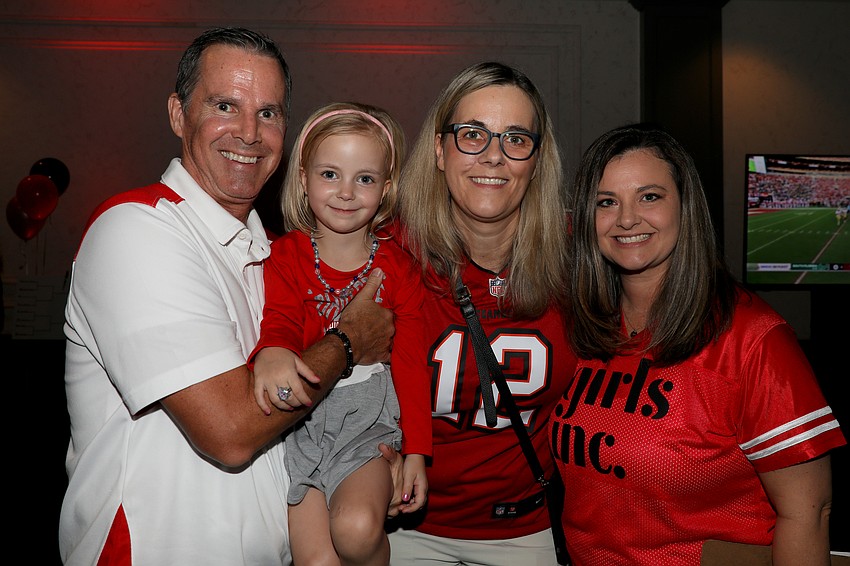 Eric Adams is godfather to the youngest guest at the Totally Tailgate event, Cleo Bosmans, shown with Val Bosman, and Jamie Katirein, director of community relations and advocacy for Girls Inc.