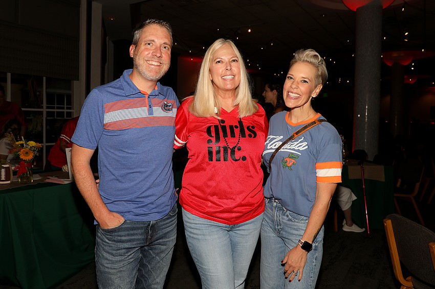 Totally Tailgate event co-chairs Scott Perrin, and his wife, Melissa, take a time-out for photo with Julie Anderson (center), vice president of advancement at Girls Inc.
