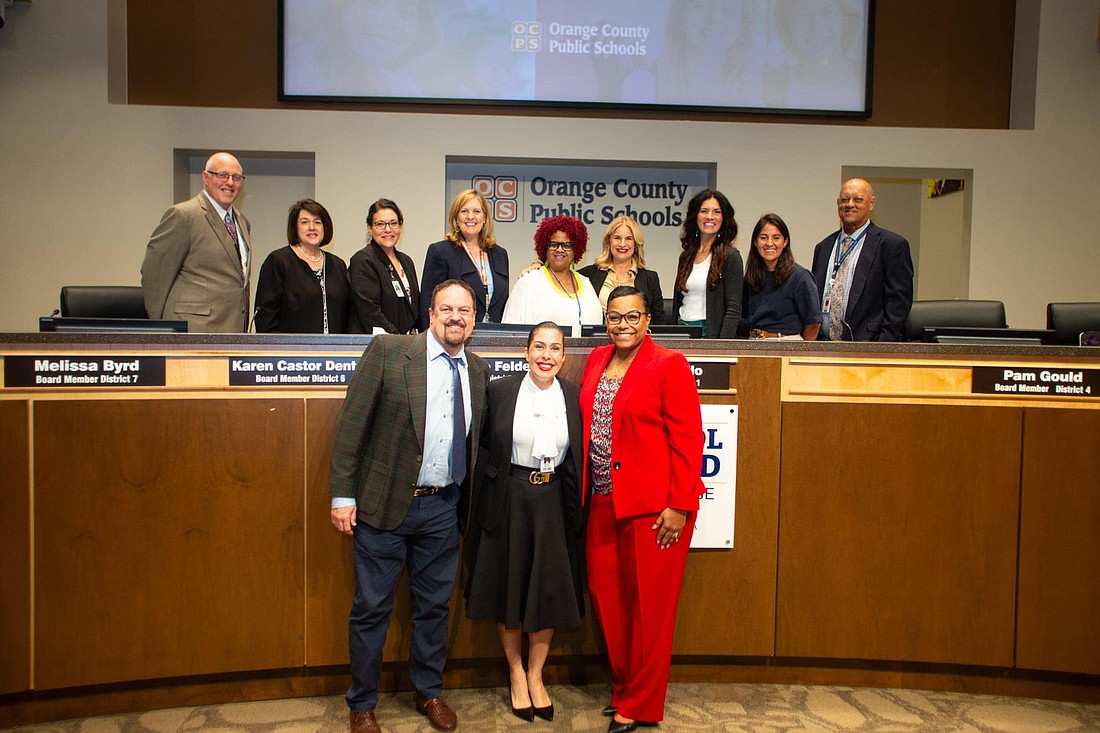 Sulimar Medina, bottom center, was officially announced as the new assistant principal for Water Spring Middle School at the Aug. 27 Orange County Public Schools School Board meeting.