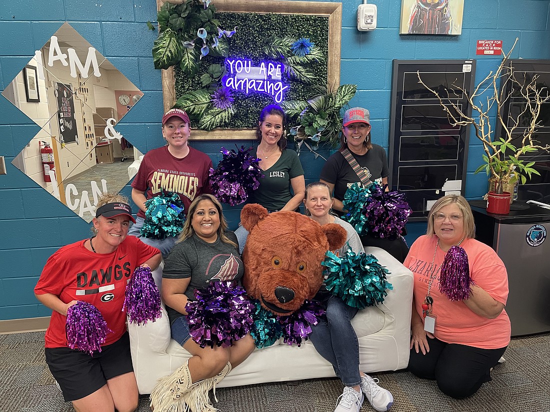 The Shenanigan Squad at Gotha Middle School: Emilee McCluskey, top left, Maureen Miller and Principal Monica Emery; Michelle Davis, bottom left, Davina Chunoo, George the mascot, Erin Hinz and Cindy Jones. Not pictured: Kimberly Do.