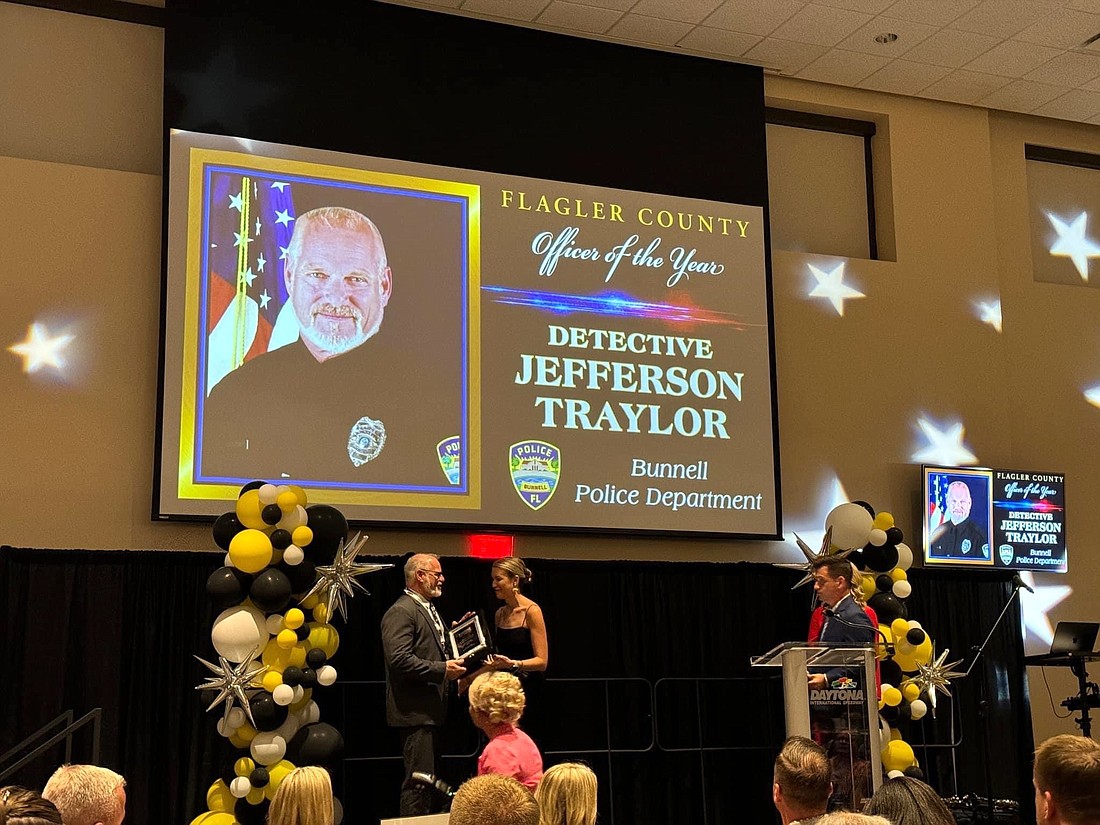 Detective Jeff Traylor is presented with a plaque from CrimeStoppers as the Flagler County Law Enforcement Officer of the Year. Courtesy photo