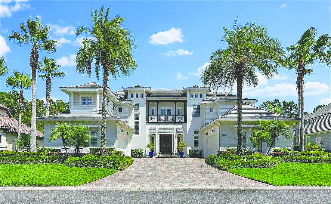 Two-story home in The Plantation at Ponte Vedra features five bedrooms, four full and one half-bathrooms, guest suite, flex room, wine cellar, screened courtyard pool, outdoor kitchen, screened putting green and half basketball court, porches, balcony and four-car garage.