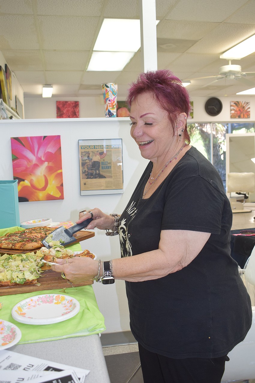 Tia Chowanski-Doty eating pizza at Design 2000 at Summer Night Out.