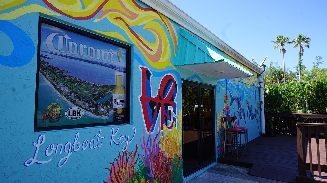 The exterior mural at Guppy's Longboat Key was commissioned by local duo Foxxy Fine Art.