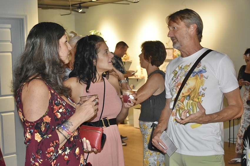 Virginia Bright and Gina Fortino talk with Chalk Festival manager Bill Baranowski.