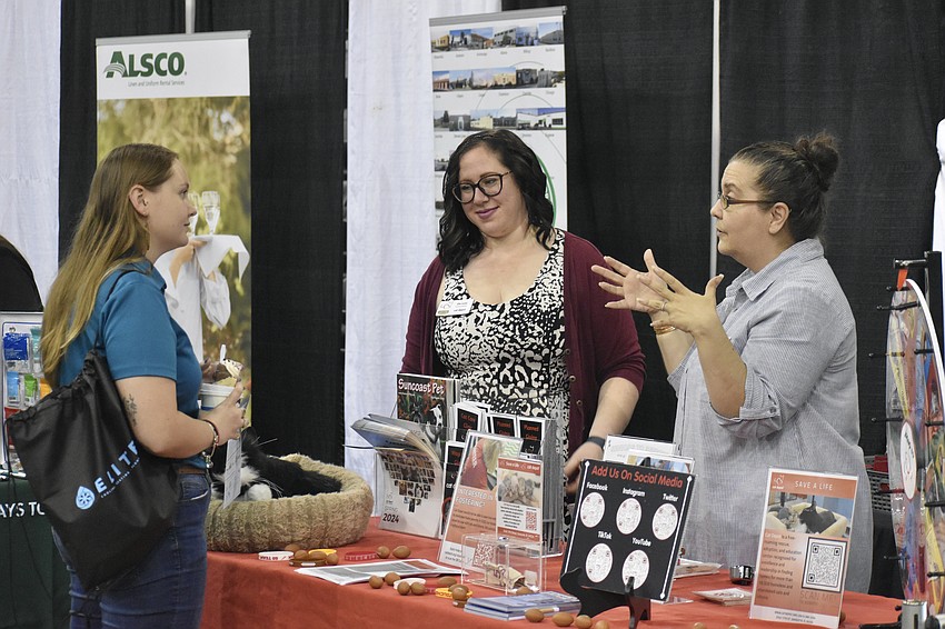 Samantha Harris of Humane Society of Manatee County connects with Ellie Levine and Claudia Harden of Cat Depot in Sarasota.