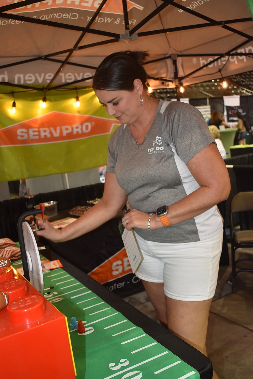 Darla Latokhin of Top Dog Trainer spins the wheel for Servpro.