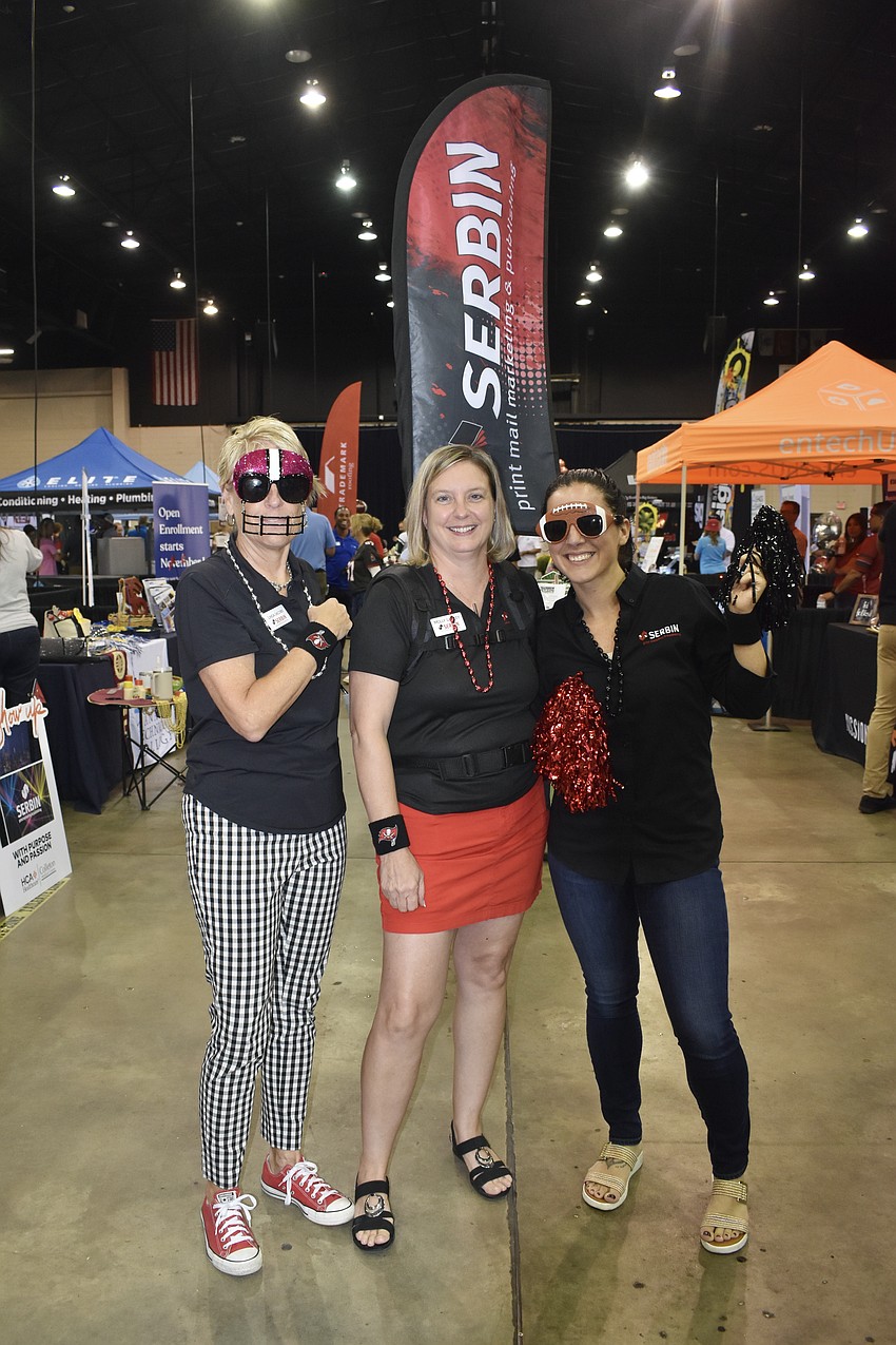 Linda Jacobs, Molly Lawley and Holly Haas of Serbin Print Marketing & Publishing brought plenty of gear, including the Serbin sign on Lawley's back.