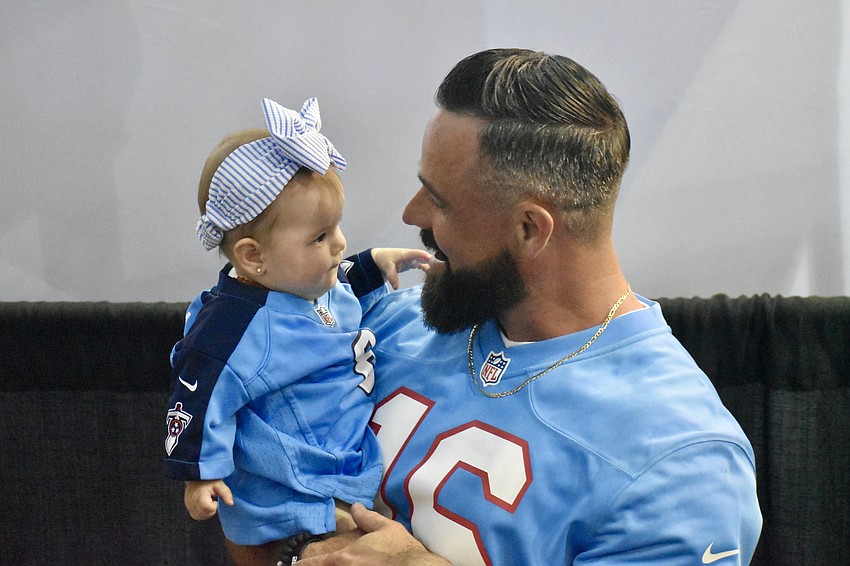 6-month old Sunday Martin and her father Devin Martin dressed up as part of a team for DecoCrete Services.