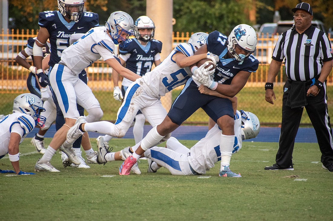 ODA junior running back Allen Clark carries Sarasota Christian defenders down the field for a big gain.