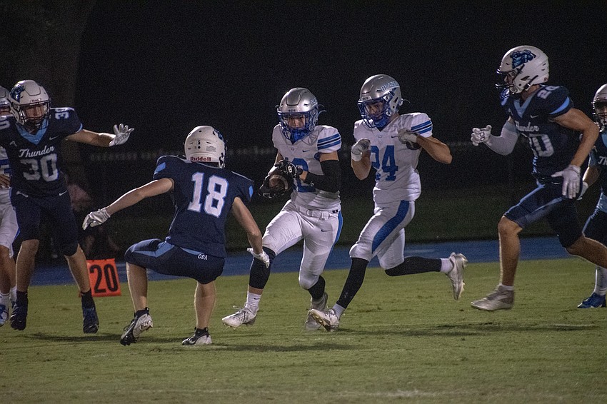 ODA sophomore Nathan Crews (18) stares down Sarasota Christian junior Travis Miller (12) on a kick return.