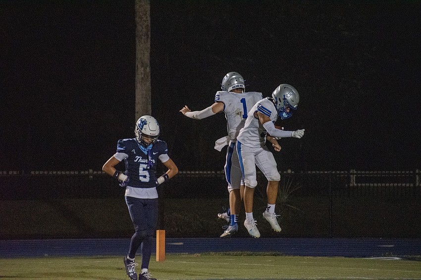 Sarasota Christian's Ben Milliken and Justin Brock celebrate after a Brock touchdown.