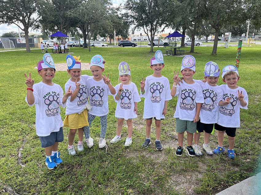 Gilbert W. McNeal Elementary School kindergartners give a sign of peace.